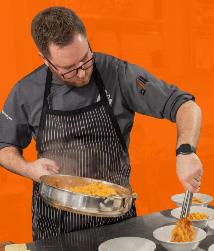 Chef Ben Plating Pasta on an orange background